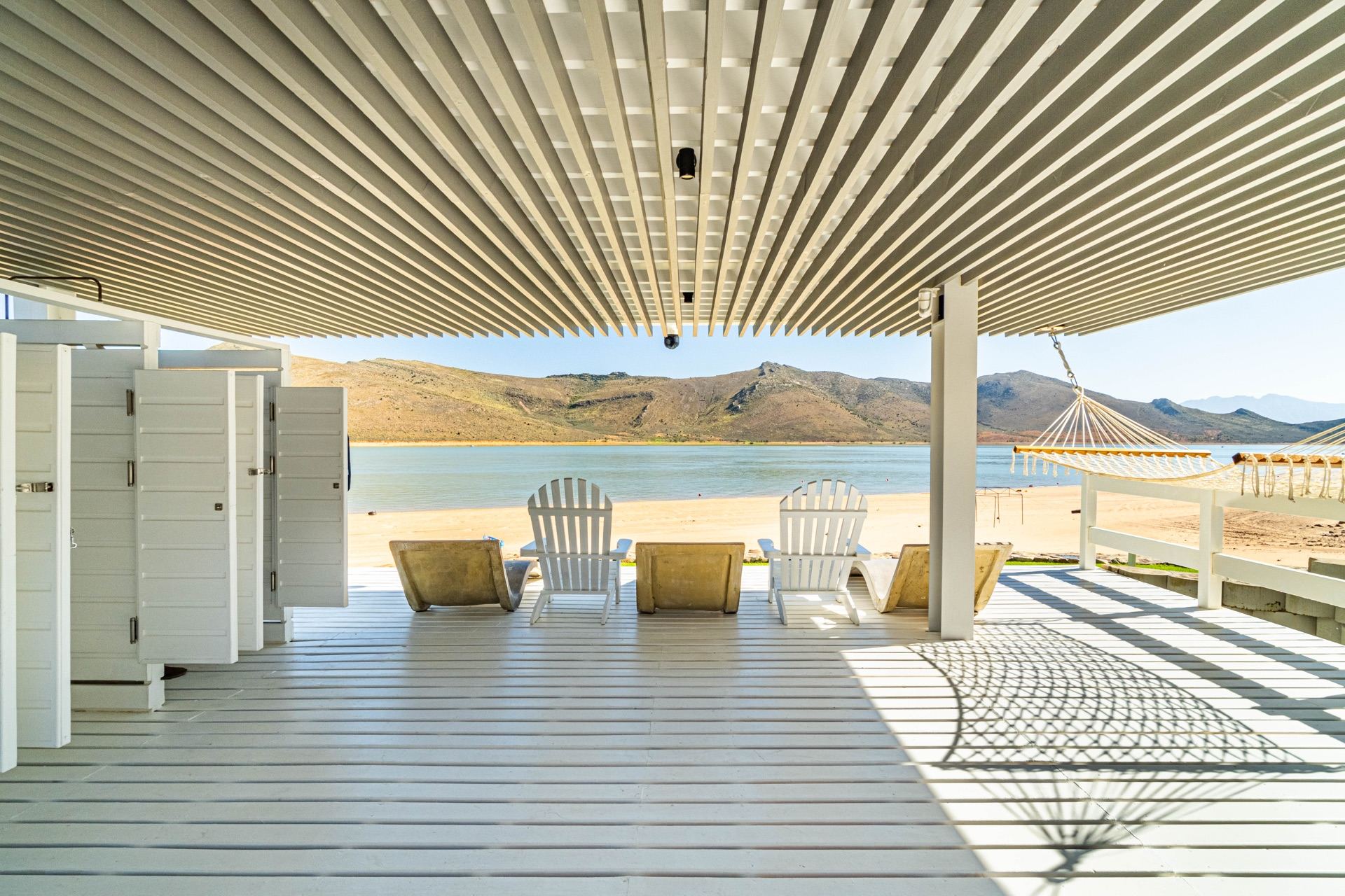 The villa's covered deck, looking over the dam to the mountains.